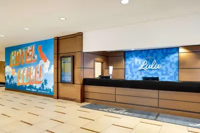 a lobby of a hotel with a reception desk at Hotel Lulu, BW Premier Collection in Anaheim