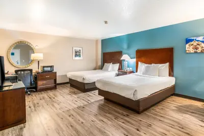 a hotel room with two beds and a television at Hotel Hacienda at Ontario Ranch in Ontario