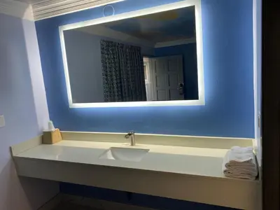 a bathroom with a sink and a mirror at Golden West Manor Motel in Los Angeles