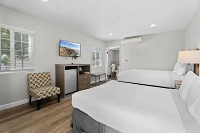 a hotel room with a bed and a chair at Ocean Park Inn in Los Angeles