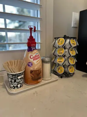 a counter with a bottle of carolina fires and muffins at Ocean Park Inn in Los Angeles