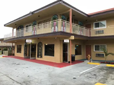 a large building with a balcony on top of it at Los Angeles Inn & Suites - LAX in Los Angeles
