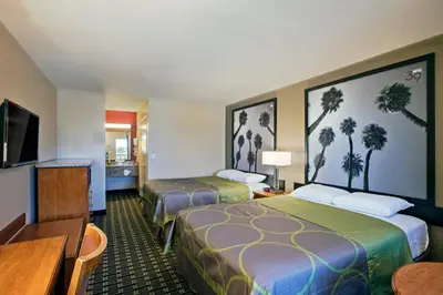 a hotel room with two beds and a flat screen tv at The Hotel 39 in Westminster