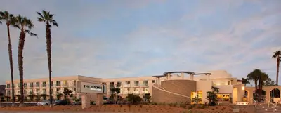 a large building with palm trees in front of it at Redondo Beach Hotel, Tapestry Collection by Hilton in Redondo Beach