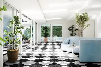 a living room with a black and white checkered floor at Short Stories Hotel Near The Grove in Los Angeles