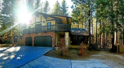 a house with a balcony and a garage at The Lodge at Snow Summit Home in Big Bear Lake
