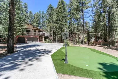 a golf course in front of a house at The Lodge at Snow Summit Home in Big Bear Lake
