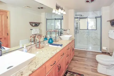 a bathroom with a sink and a toilet and a shower at The Lodge at Snow Summit Home in Big Bear Lake