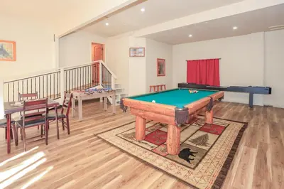 a room with a pool table and a dining room at The Lodge at Snow Summit Home in Big Bear Lake