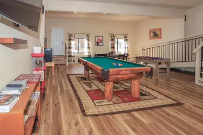 a living room with a pool table in it at The Lodge at Snow Summit Home in Big Bear Lake