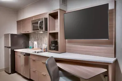 a kitchen with a large flat screen tv on the wall at TownePlace Suites by Marriott Los Angeles LAX/Hawthorne in Hawthorne