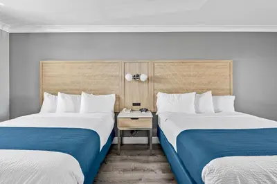 two beds sitting next to each other in a room at Vagabond Inn Whittier in Whittier