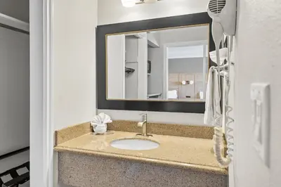 a bathroom with a sink and a mirror at Vagabond Inn Whittier in Whittier