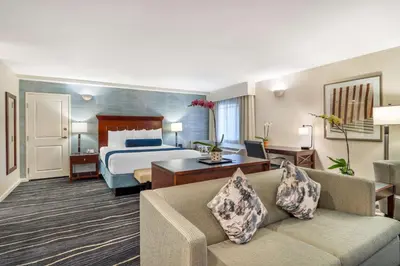 a hotel room with a bed and a couch at Best Western Plus Carpinteria Inn in Carpinteria