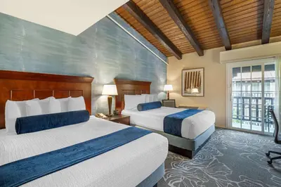 a hotel room with two beds and a window at Best Western Plus Carpinteria Inn in Carpinteria