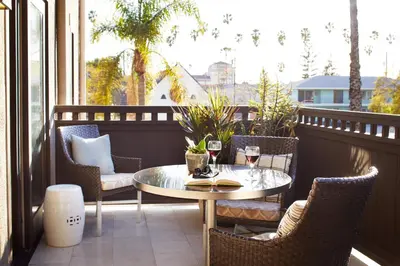 a patio with a table and chairs on a balcony at Ambrose Hotel in Los Angeles