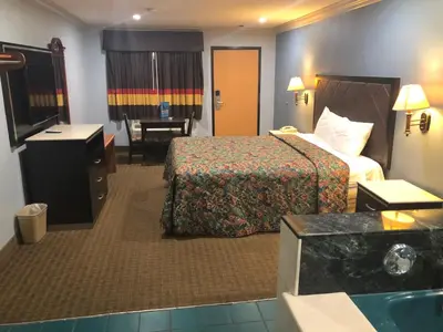 a hotel room with a bed and a desk at La Mirage Inn LAX Airport in Los Angeles