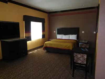 a hotel room with a bed and a television at Diamond Inn in Inglewood