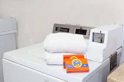 a pile of towels sitting on top of a machine at Days Inn by Wyndham Anaheim West in Anaheim