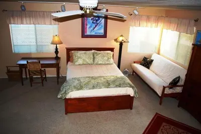 a bedroom with a bed and a couch and a table at 