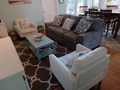 a living room with a couch and chairs and a table at 