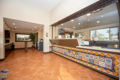 a restaurant with a counter with a tile floor at Casa Bella Inn- Huntington Park in Huntington Park