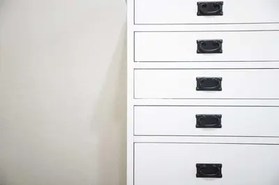 a white chest of draws with black handles at Hotel Carmel Santa Monica in Los Angeles