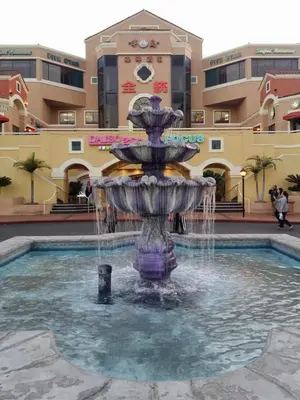 a fountain in the middle of a pool in a mall at Valley Hotel in Rosemead