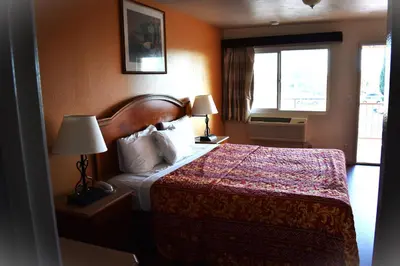 a hotel room with a bed and a window at Valley Hotel in Rosemead