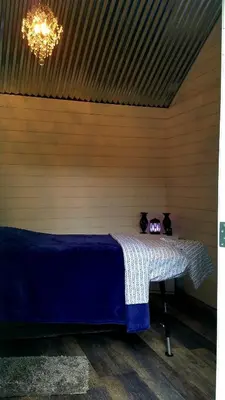 a room with a table with a blue blanket on it at Sacred Mtn River Suites in Kernville
