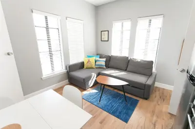 a living room with a couch and a table at Broadlind Hotel in Long Beach