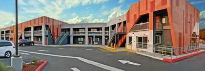 a parking lot in front of a building at Epic Hotel in Pico Rivera