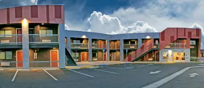 a building with a parking lot in front of it at Epic Hotel in Pico Rivera