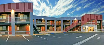a building with a parking lot in front of it at Epic Hotel in Pico Rivera