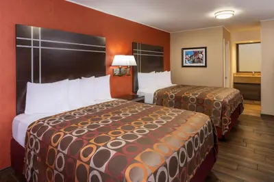 a hotel room with two beds in a room at Best Western Plus Raffles Inn & Suites in Anaheim