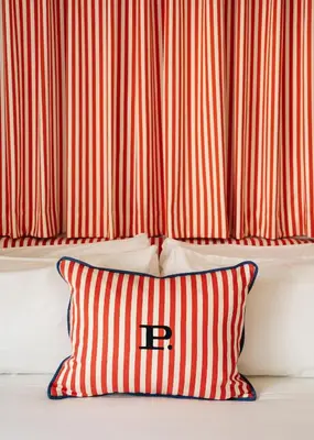 a red and white striped pillow in front of a curtain at Palihotel Melrose in Los Angeles