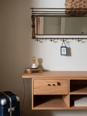 a wooden dresser with a mirror on top of it at Palihotel Melrose in Los Angeles