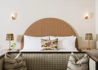 a bedroom with a large bed and two lamps at Palihotel Melrose in Los Angeles