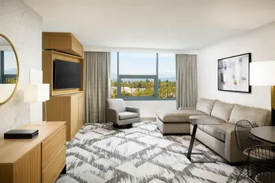 a living room with a couch and a tv at Sheraton Cerritos in Buena Park