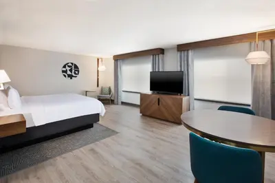 a hotel room with a bed and a table and a tv at Holiday Inn Ontario Airport - California by IHG in Ontario