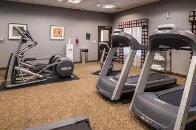 a gym with two tread machines and a treadmill at Holiday Inn Ontario Airport - California by IHG in Ontario