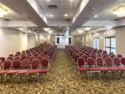 a room with rows of chairs in a hall at Park Suites Hotel in South El Monte
