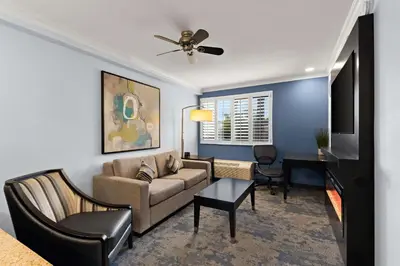 a living room with a couch and a table at City Express by Marriott Manhattan Beach in Manhattan Beach