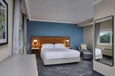 a bedroom with a bed and a blue wall at DoubleTree by Hilton Chatsworth in Chatsworth