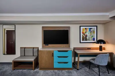 a hotel room with a desk and a flat screen tv at DoubleTree by Hilton Chatsworth in Chatsworth