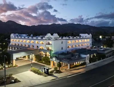 an aerial view of a building with mountains in the background at DoubleTree by Hilton Chatsworth in Chatsworth