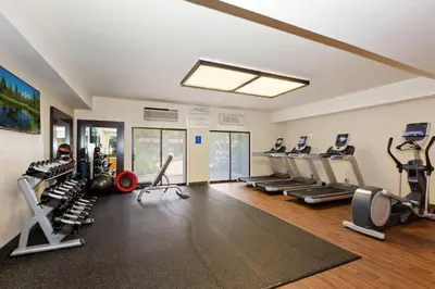 a gym with several treadmills and cardio machines at Doubletree by Hilton Whittier in Whittier