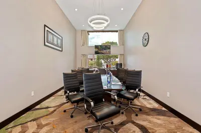 a dining room with a table and black chairs at Doubletree by Hilton Whittier in Whittier