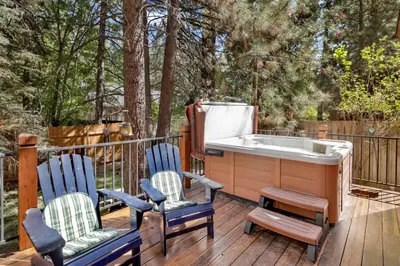a bath tub sitting on a deck with two chairs at Dreams of Summit-1120 by Big Bear Vacations in Big Bear Lake
