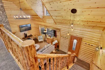 a view of a living room in a log cabin at Dreams of Summit-1120 by Big Bear Vacations in Big Bear Lake